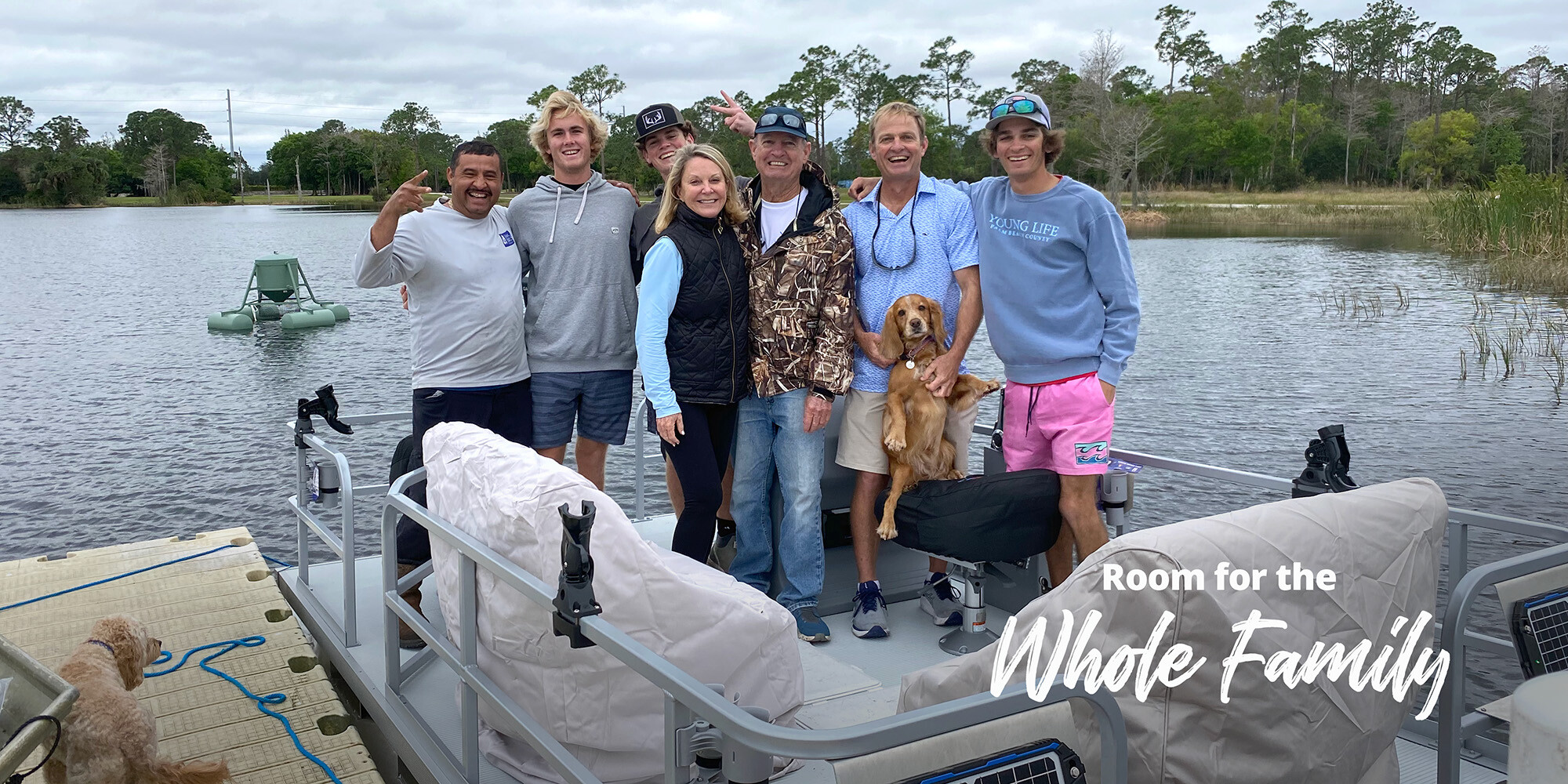 Family with dog on pontoon boat